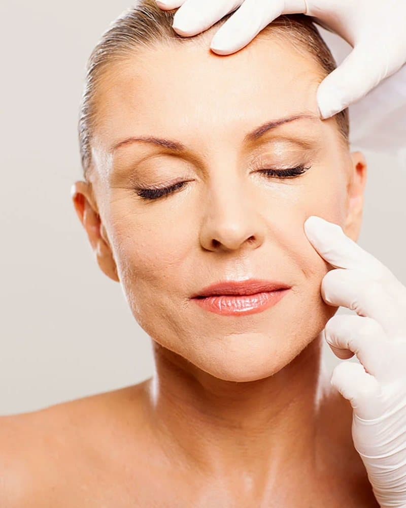 A client having her face examined before treatment at Mike Lee Laser & Skin Clinic
